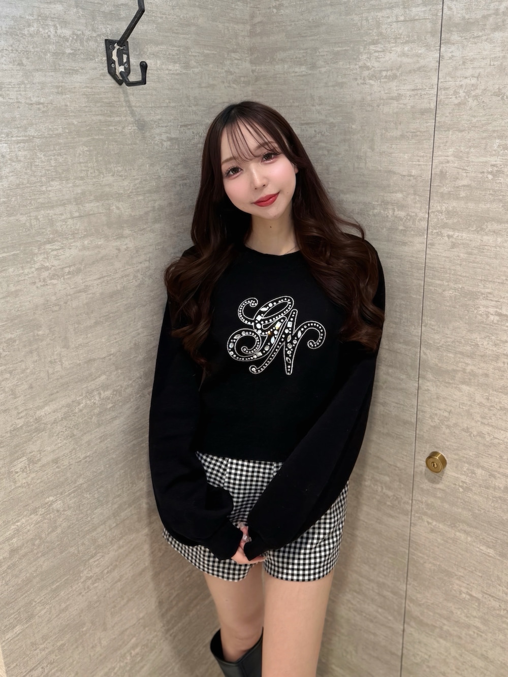 ブラック系のその他パンツ、ブラック系のニット/セーター、ブラック系のブーツを着用したレディースの春コーディネートの4枚目の写真