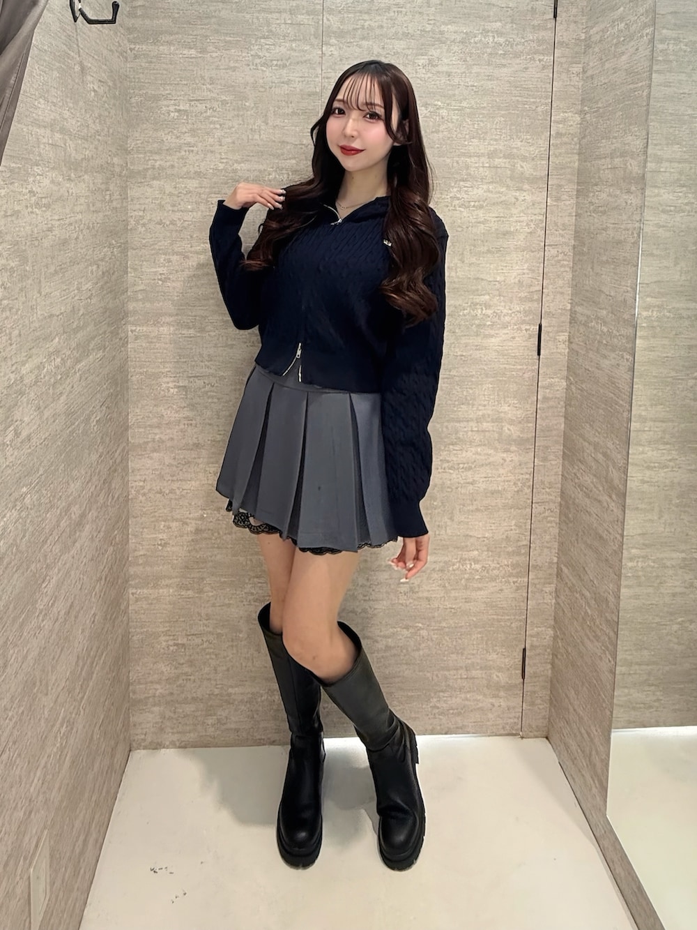 ブルー系のパーカー、グレー系のスカート、ブラック系のブーツを着用したレディースの冬コーディネートの2枚目の写真