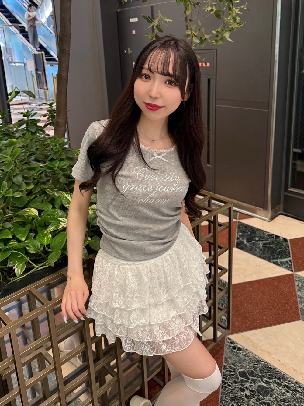 グレー系のTシャツ/カットソー、ホワイト系のスカート、ホワイト系のサンダルを着用したレディースの夏コーディネートの5枚目の写真