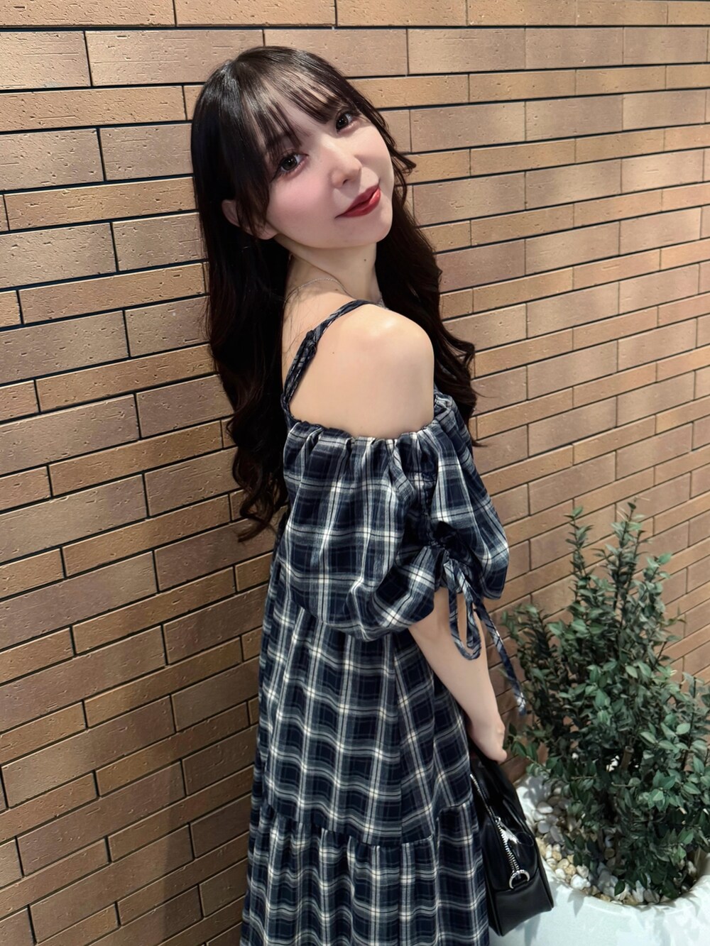 ブルー系のワンピース、ブラック系のハンドバッグ、ホワイト系のサンダルを着用したレディースの夏コーディネートの7枚目の写真