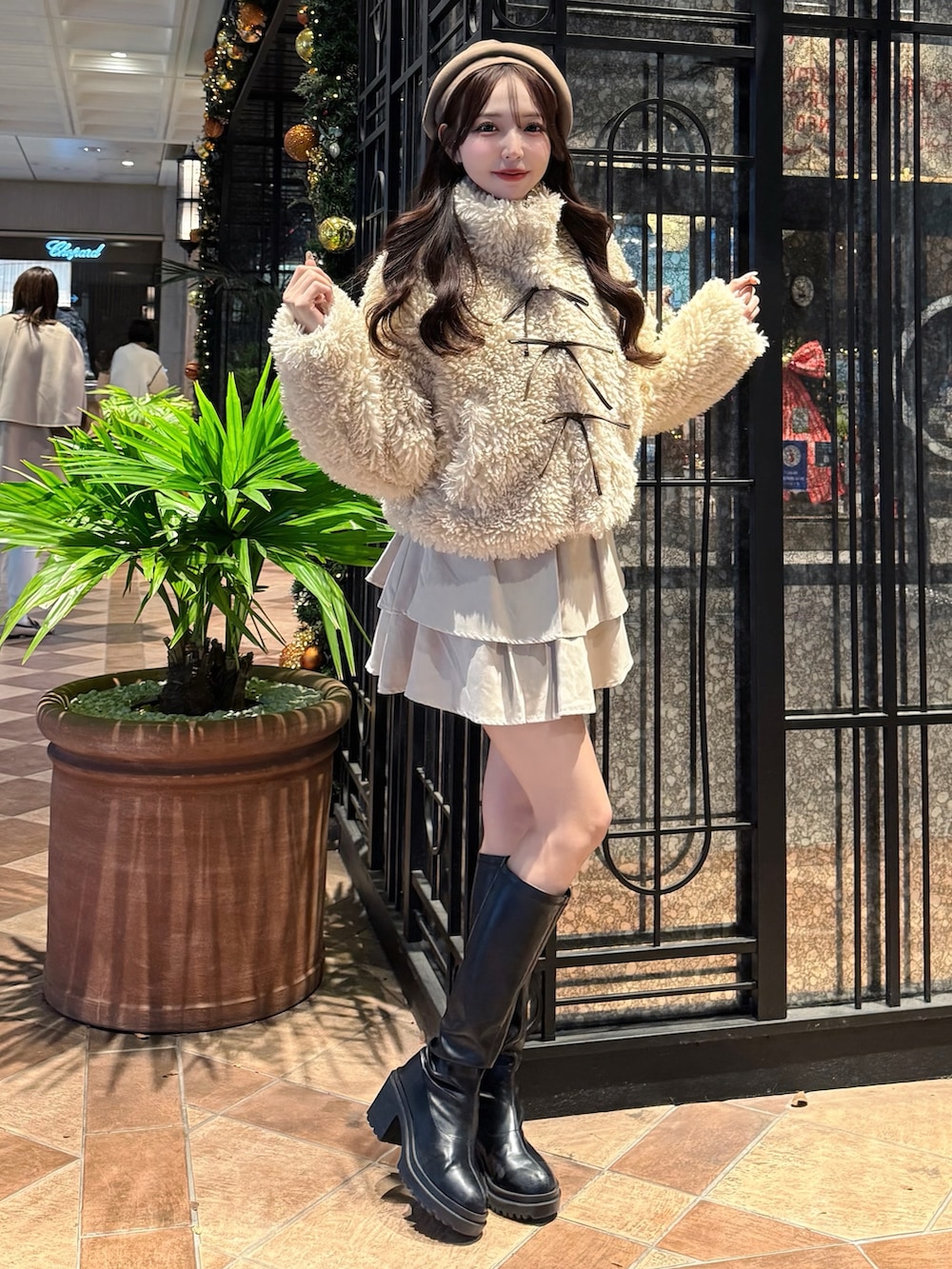 ベージュ系のブルゾン、ホワイト系のスカート、ベージュ系のハンチング/ベレー帽を着用したレディースの冬コーディネートの3枚目の写真