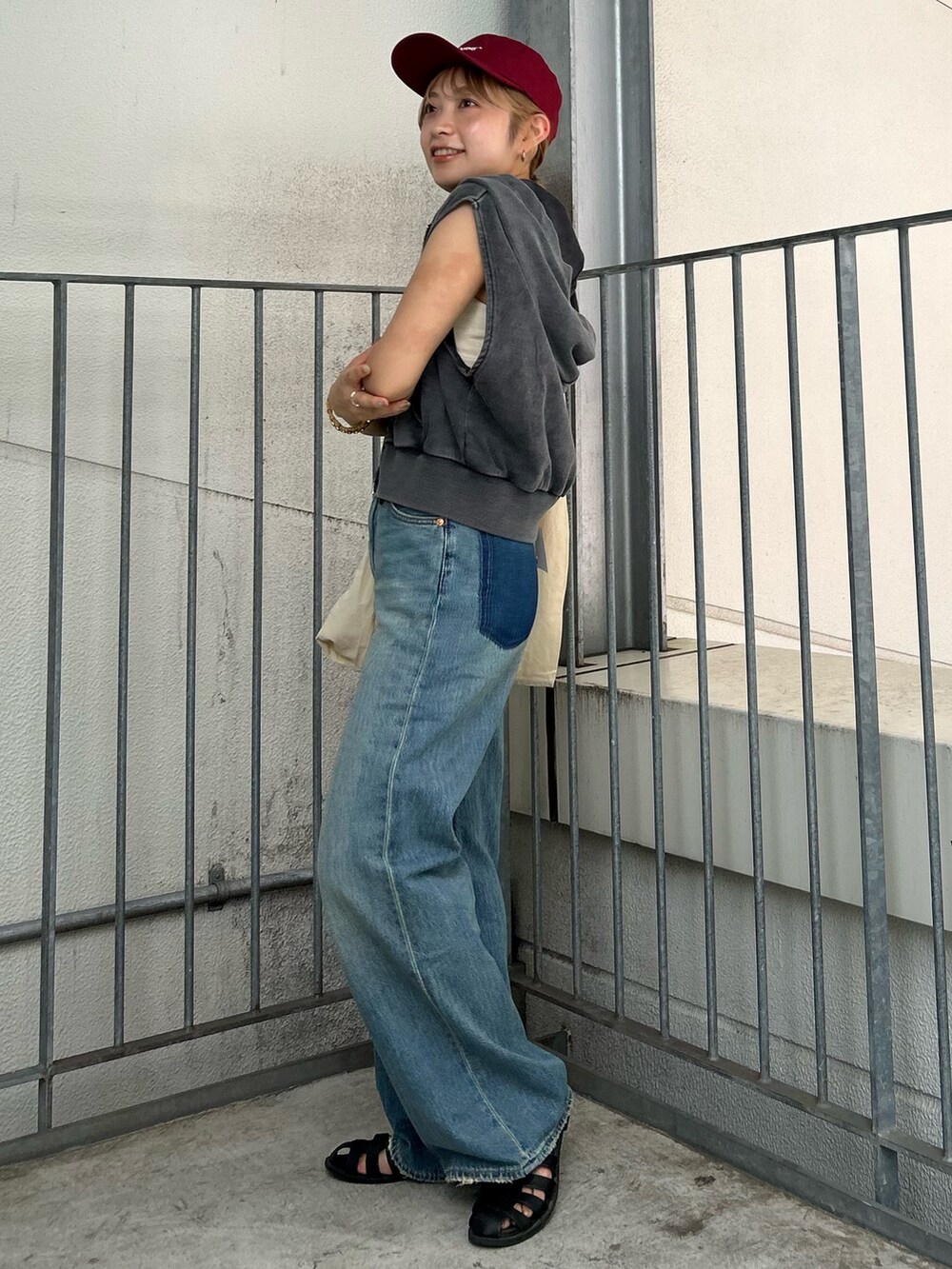 ブルー系のデニムパンツ、グレー系のパーカー、ホワイト系のトートバッグを着用したレディースの夏コーディネートの2枚目の写真