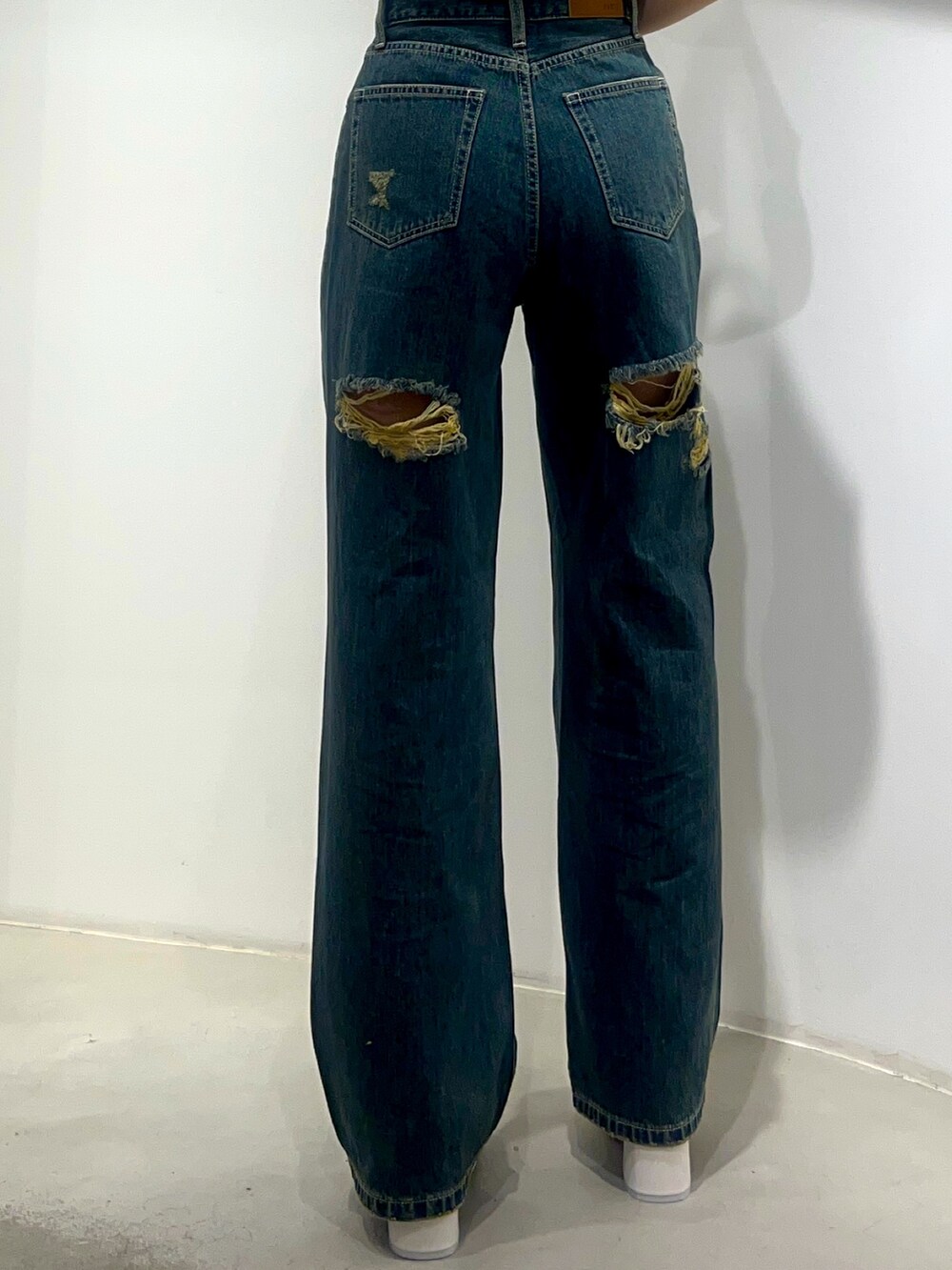 ブルー系のデニムパンツ、ホワイト系のサンダル、グレー系のニット/セーターを着用したレディースの夏コーディネートの5枚目の写真