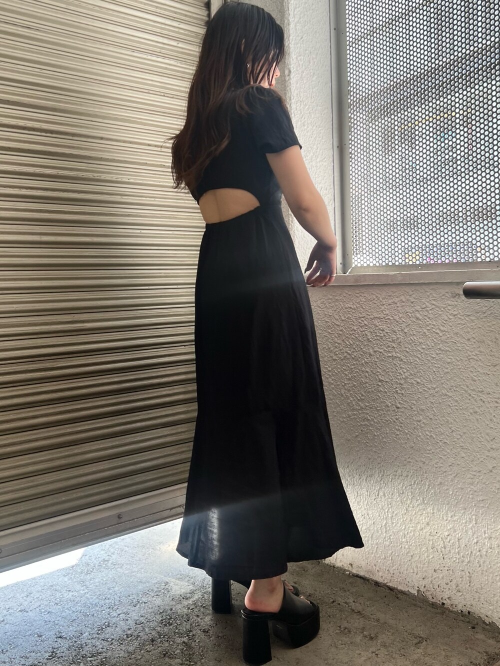 ブラック系のワンピース、ブラック系のショルダーバッグ、ブラック系のサンダルを着用したレディースの夏コーディネートの3枚目の写真