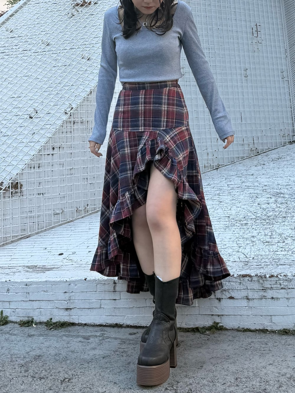 ブルー系のスカート、ブラック系のブーツ、グレー系のTシャツ/カットソーを着用したレディースの冬コーディネートの4枚目の写真