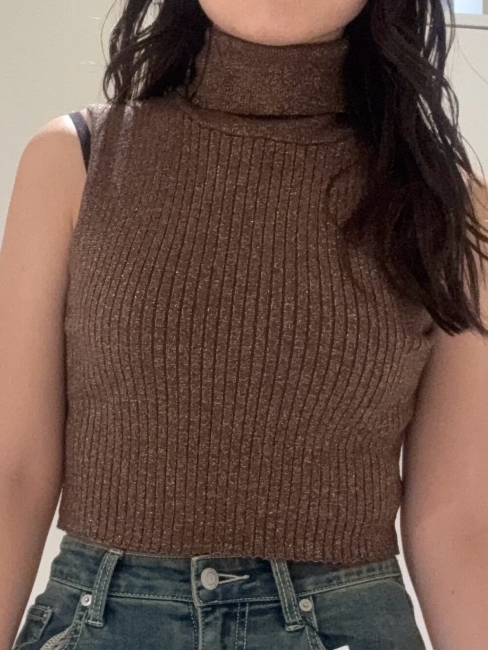 ブラック系のブーツ、ブルー系のデニムパンツ、ブラウン系のタンクトップを着用したレディースの秋コーディネートの4枚目の写真