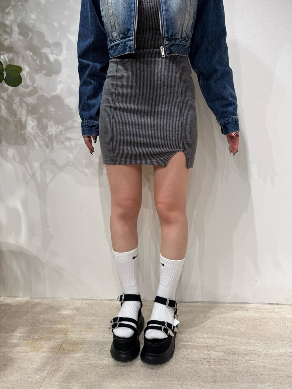 グレー系のワンピース、ブルー系のデニムジャケット、ブラック系のサンダルを着用したレディースの春コーディネートの6枚目の写真