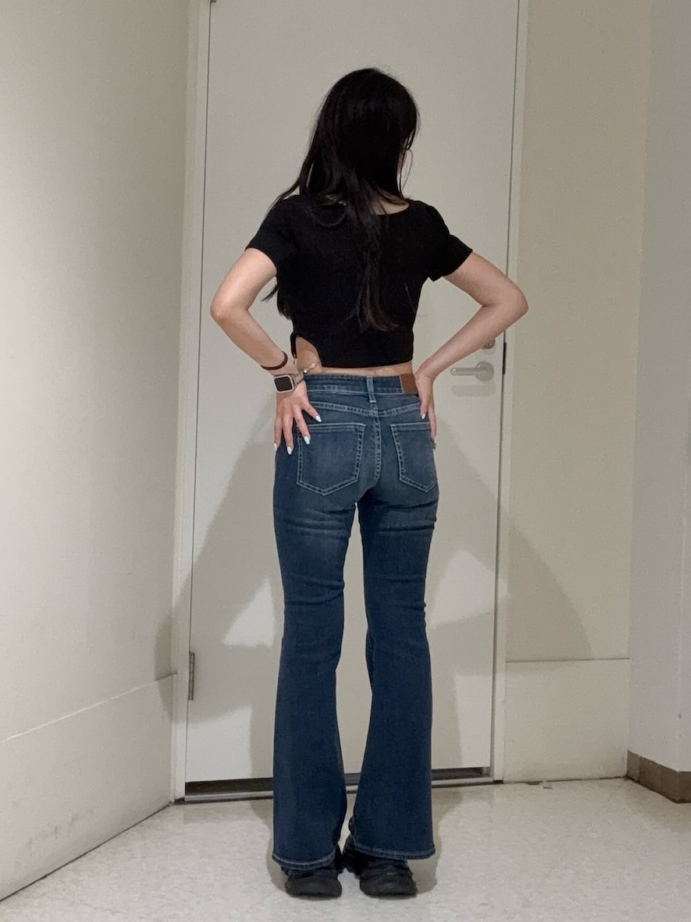 ブラック系のTシャツ/カットソー、ブルー系のデニムパンツ、ブラック系のサンダルを着用したレディースの春コーディネートの3枚目の写真