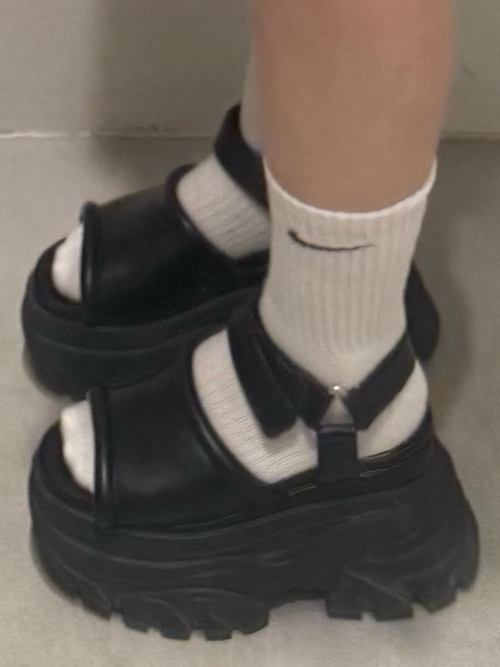 ブラック系のタンクトップ、ブラウン系のサンダル、ブルー系のデニムパンツを着用したレディースの夏コーディネートの5枚目の写真