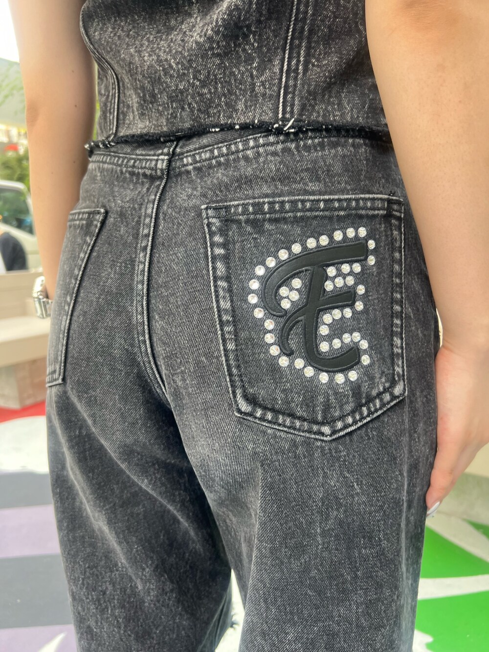 ブラック系のデニムパンツ、ブラック系のサンダル、ブラック系のキャミソールを着用したレディースの夏コーディネートの8枚目の写真