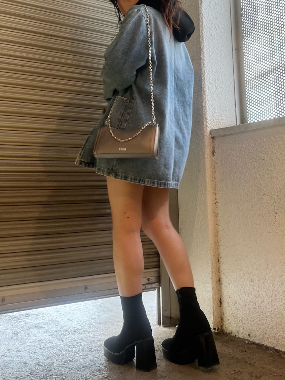 ブルー系のデニムジャケット、ブルー系のデニムパンツ、その他のブーツを着用したレディースの秋コーディネートの2枚目の写真