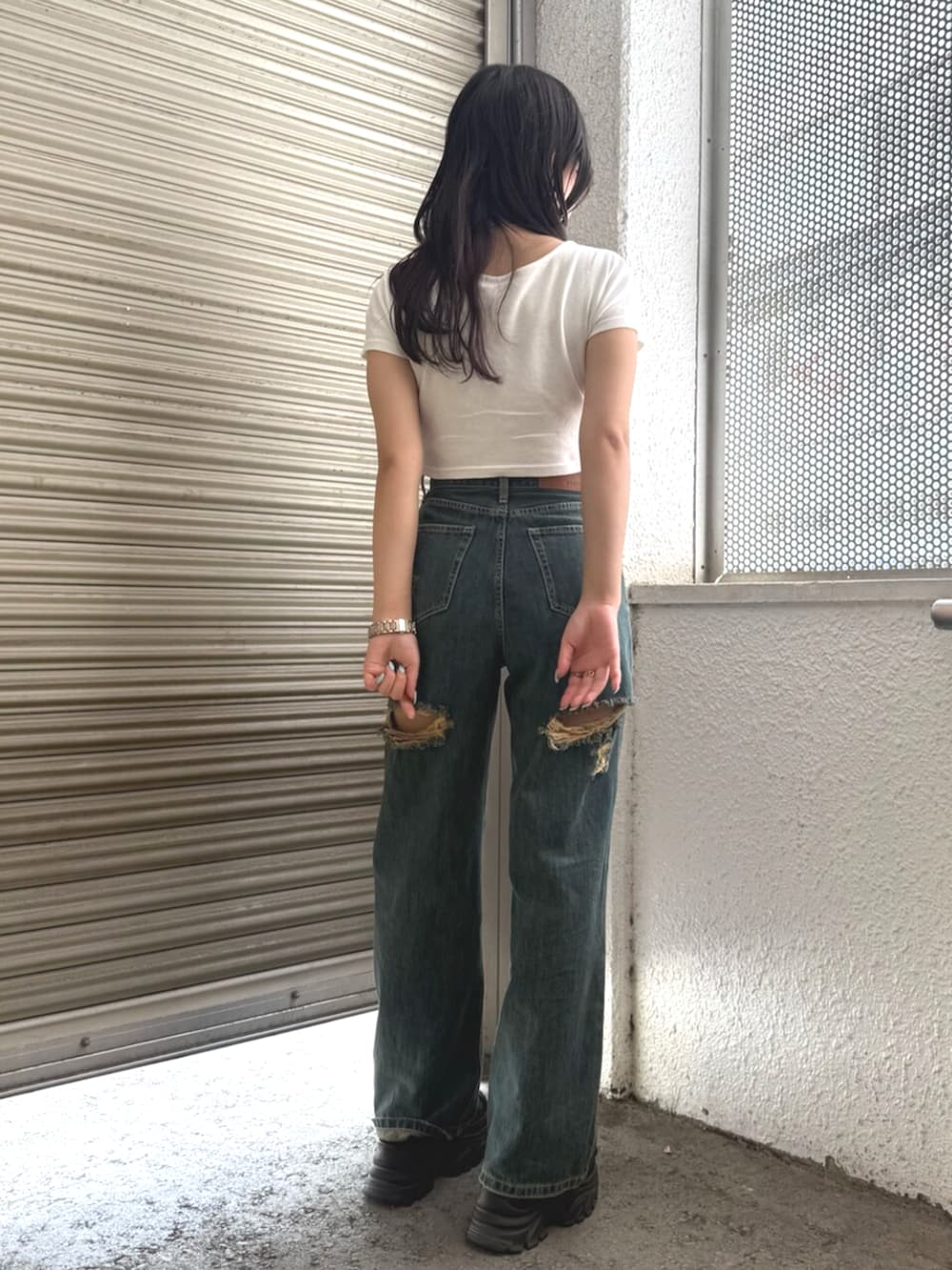 ブラウン系のサンダル、ホワイト系のTシャツ/カットソー、ブルー系のデニムパンツを着用したレディースの夏コーディネートの3枚目の写真
