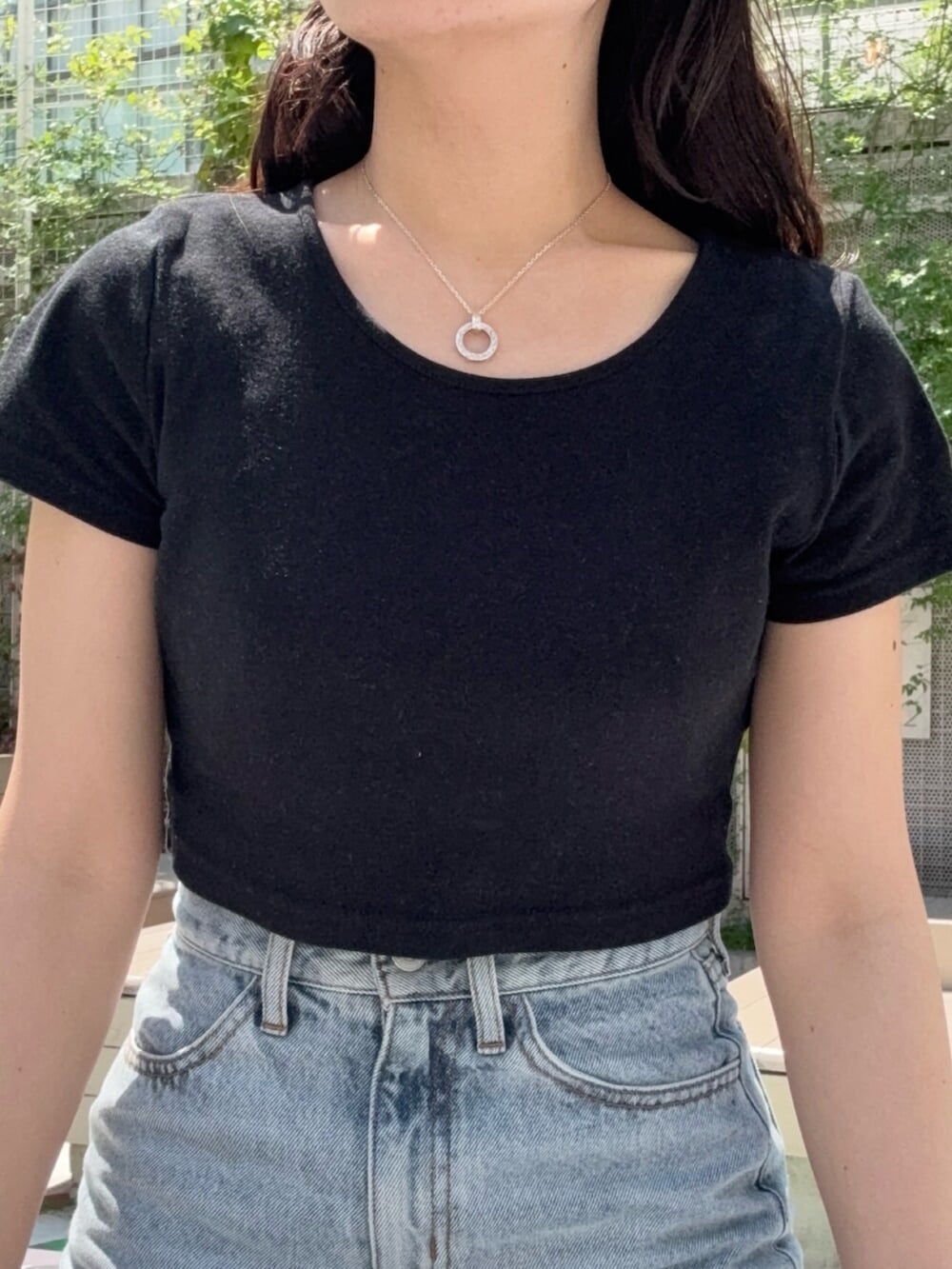 ブラウン系のサンダル、ブルー系のデニムスカート、ブラック系のTシャツ/カットソーを着用したレディースの春コーディネートの4枚目の写真