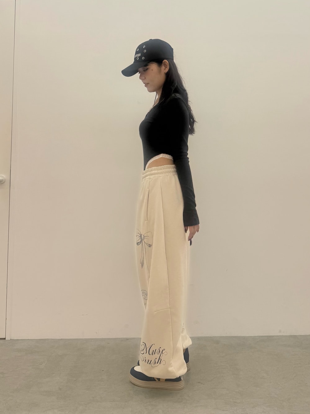 グレー系のTシャツ/カットソー、ホワイト系のスウェットパンツ、ブラック系のショルダーバッグを着用したレディースの秋コーディネートの2枚目の写真