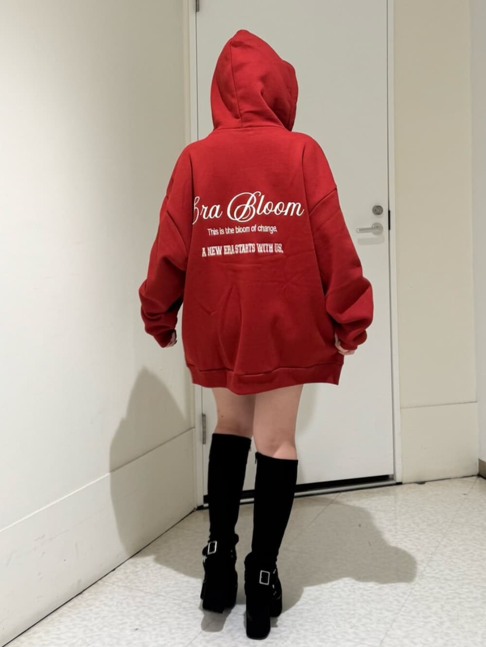 ブラック系のブーツ、レッド系のパーカーを着用したレディースの秋コーディネートの3枚目の写真