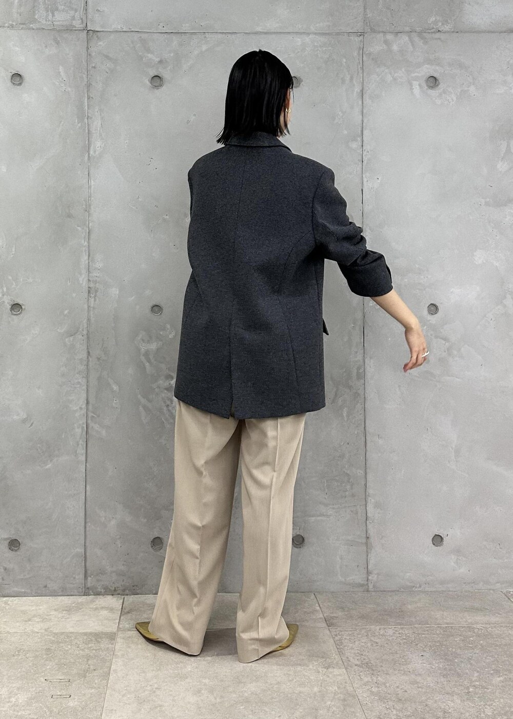 ゴールド系のパンプス、ベージュ系のスラックス、ブラック系のその他アウターを着用したレディースの秋コーディネートの4枚目の写真