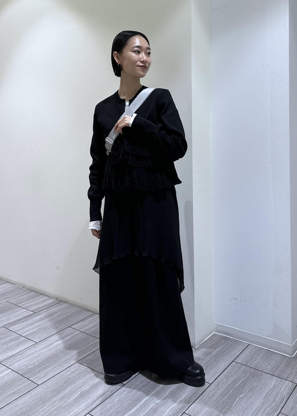 ブラック系のサンダル、ブラック系のカーディガン/ボレロ、シルバー系のショルダーバッグを着用したレディースの冬コーディネートの6枚目の写真