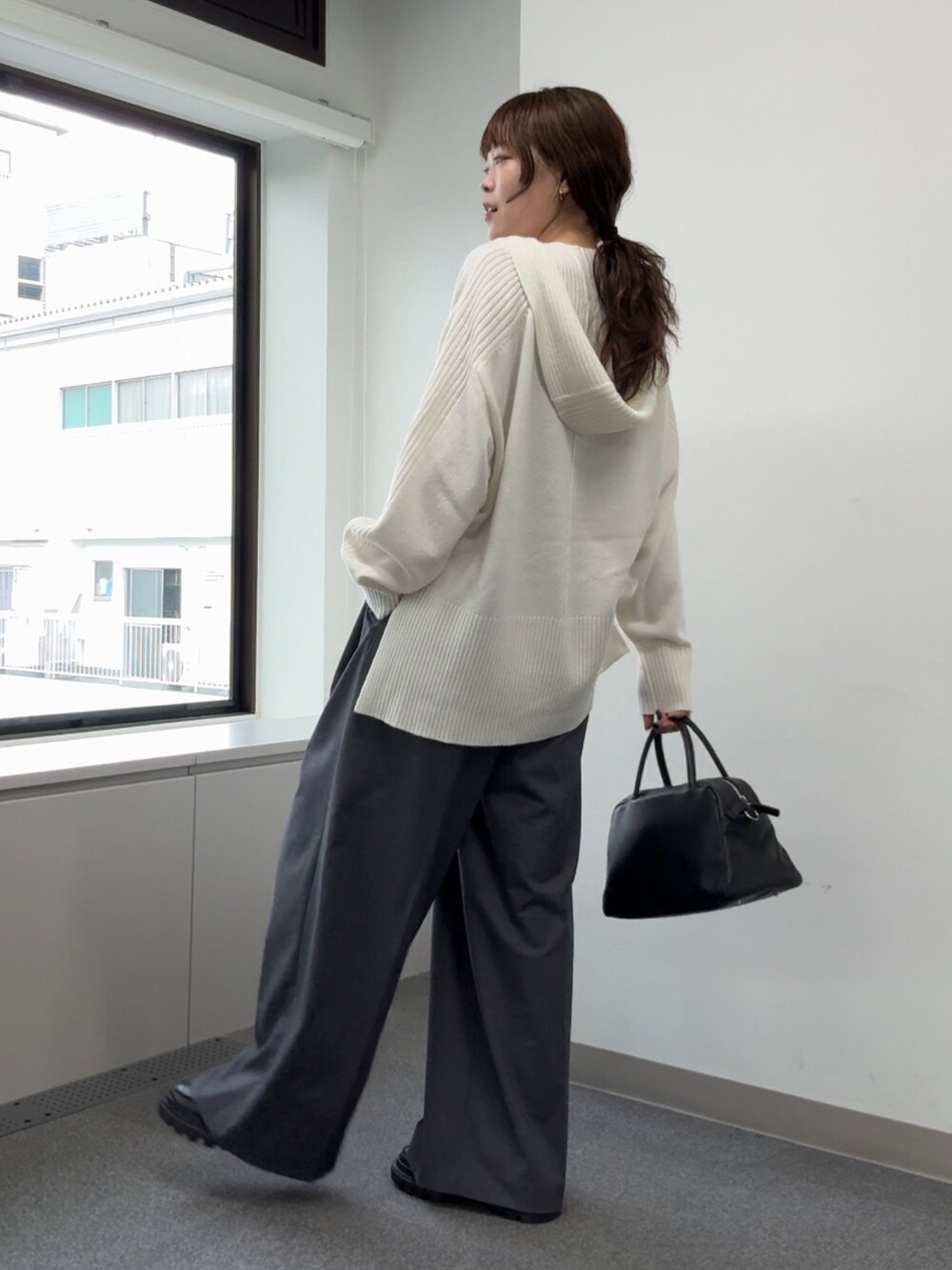 ホワイト系のニット/セーター、グレー系のその他パンツ、ブラック系のブーツを着用したレディースの秋コーディネートの6枚目の写真