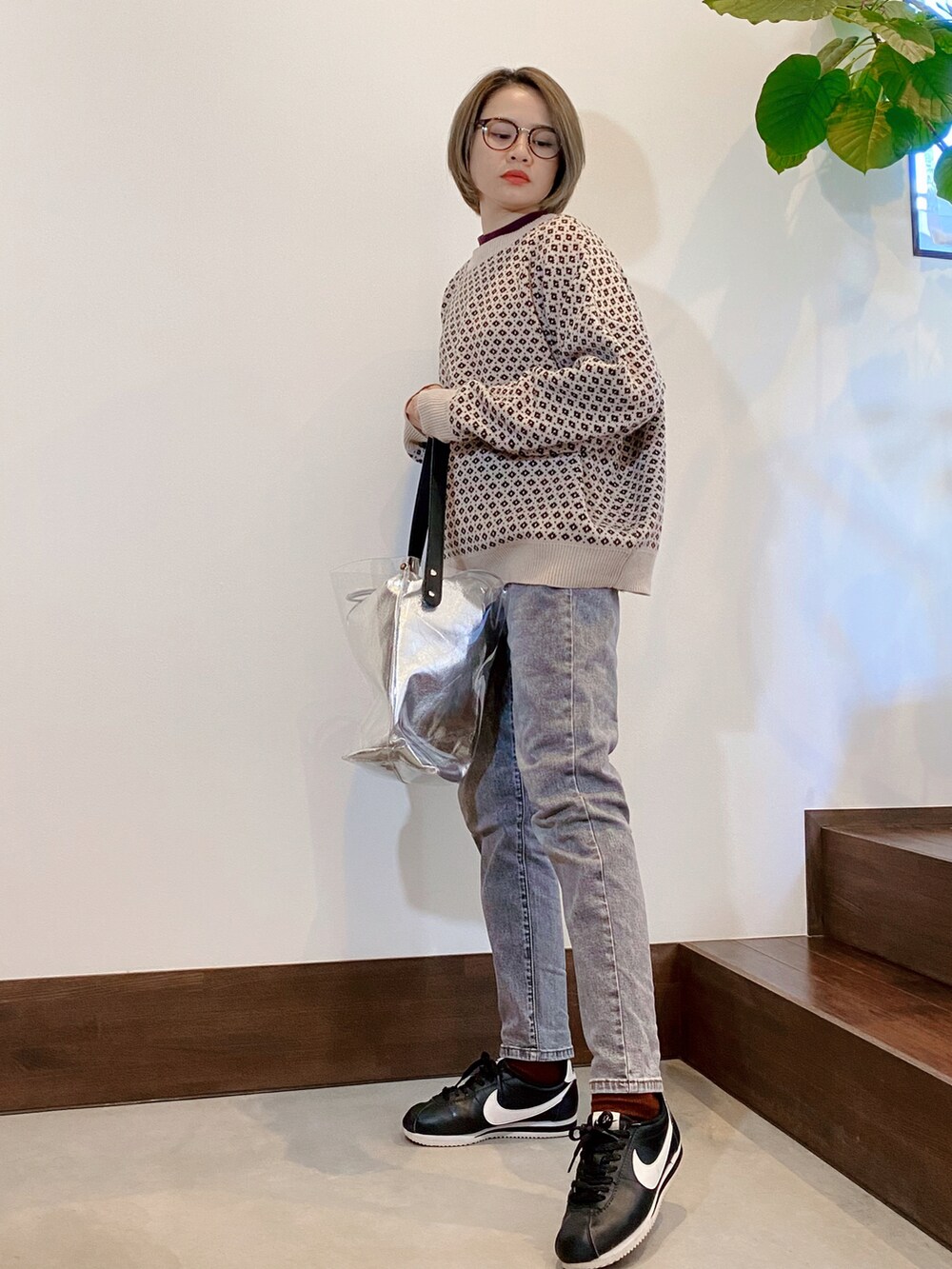 ベージュ系のカーディガン/ボレロ、ブラック系のデニムパンツ、その他のハンドバッグを着用したレディースの秋コーディネートの2枚目の写真