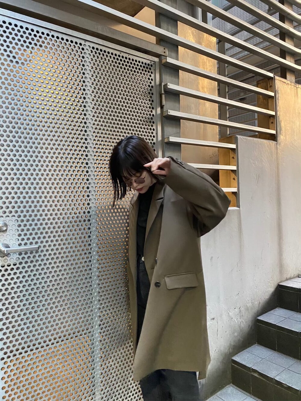 ベージュ系のテーラードジャケット、ブラウン系のパンプス、ブラック系のデニムパンツを着用したレディースの秋コーディネートの3枚目の写真