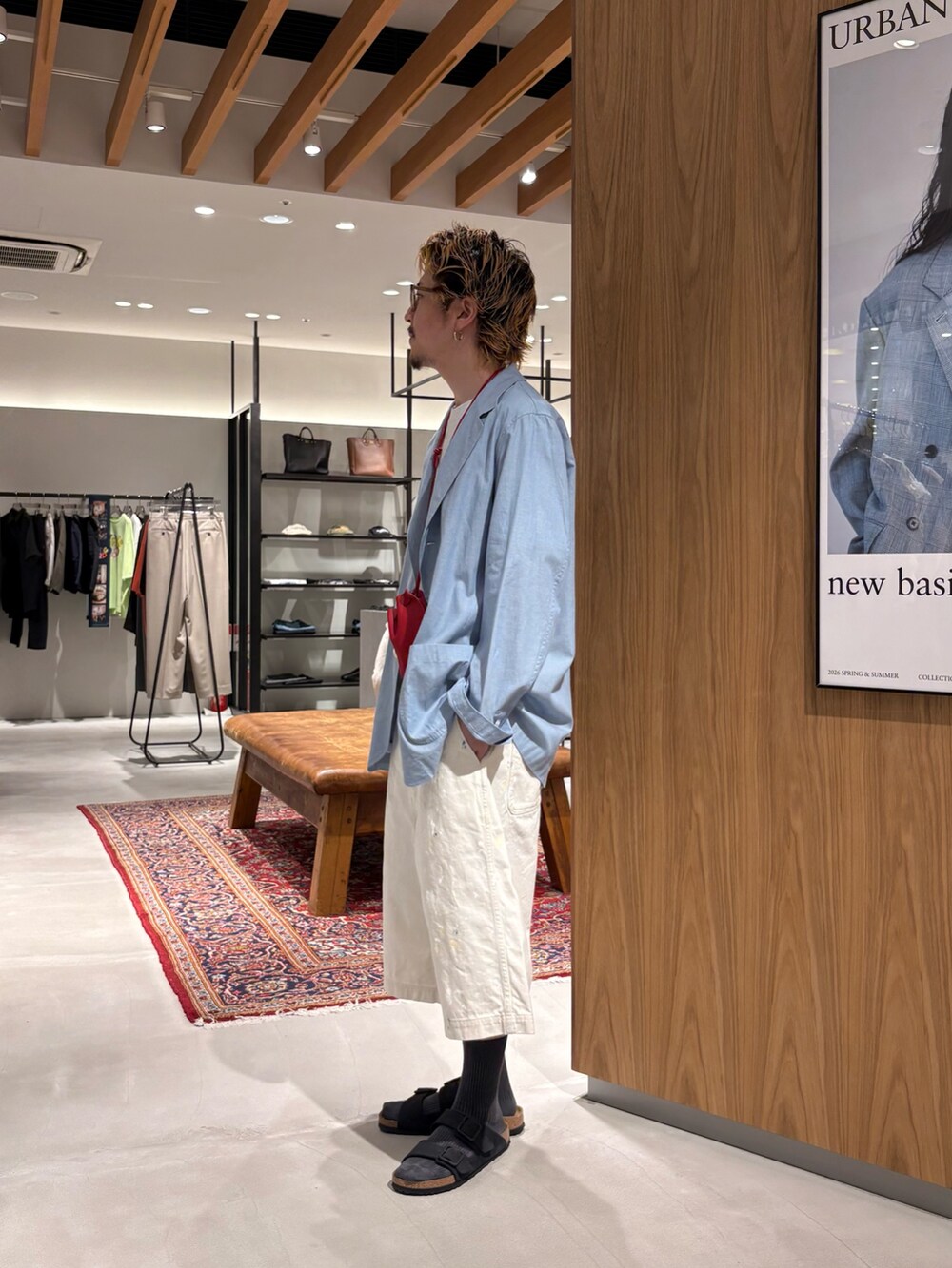 ブルー系のテーラードジャケット、ホワイト系のその他パンツ、ブラック系のサンダルを着用したメンズの夏コーディネートの3枚目の写真