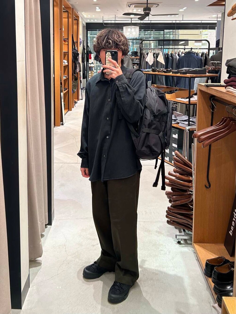 グリーン系のその他パンツ、ブラック系のスニーカー、ブラック系のシャツ/ブラウスを着用したメンズの秋コーディネートの2枚目の写真