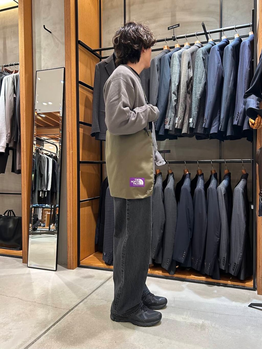 ホワイト系のニット/セーター、グレー系のカーディガン/ボレロ、グリーン系のショルダーバッグを着用したメンズの秋コーディネートの2枚目の写真