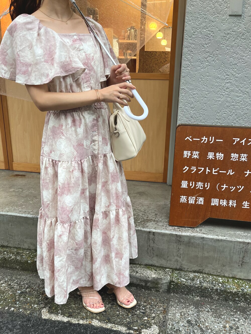 ピンク系のワンピースを着用したレディースの夏コーディネートの2枚目の写真