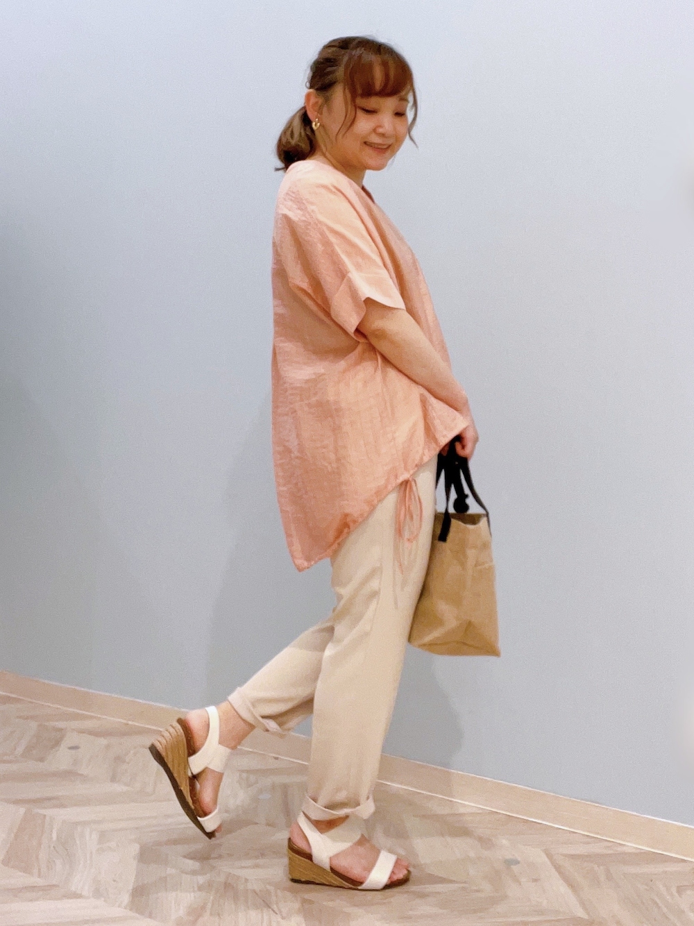 オレンジ系のシャツ/ブラウス、ベージュ系のその他パンツ、ホワイト系のサンダルを着用したレディースの夏コーディネートの2枚目の写真