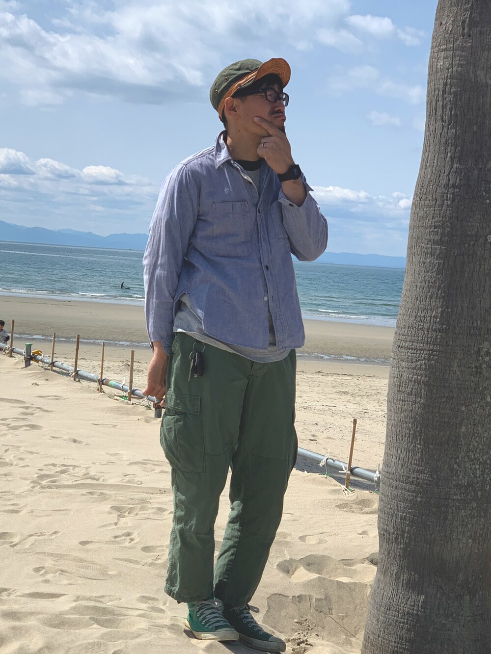 ブルー系のシャツ/ブラウス、グリーン系のカーゴパンツ、グリーン系のスニーカーを着用したメンズの春コーディネートの3枚目の写真