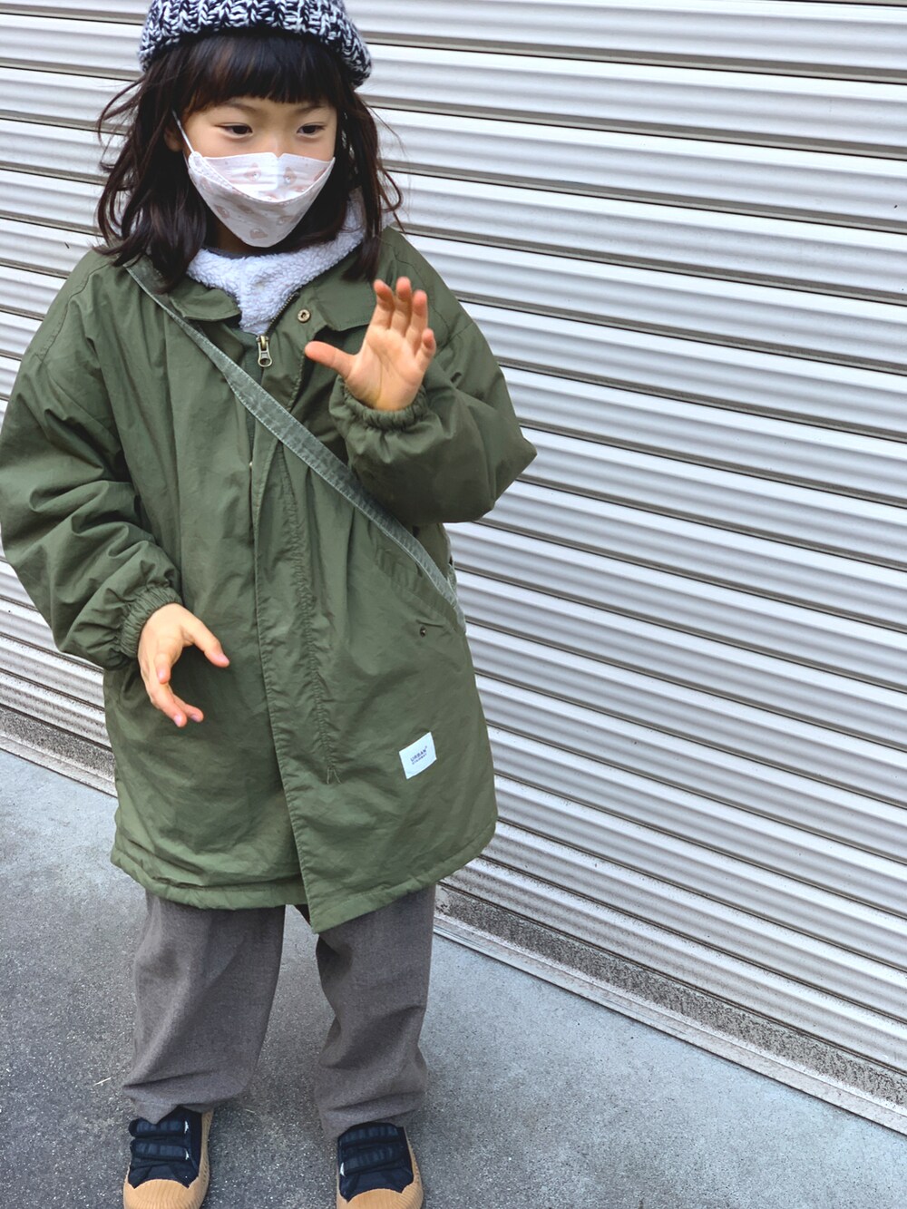 グリーン系のジャケット/アウター、グレー系のパンツ、ブラック系のスニーカーを着用したキッズの冬コーディネートの2枚目の写真