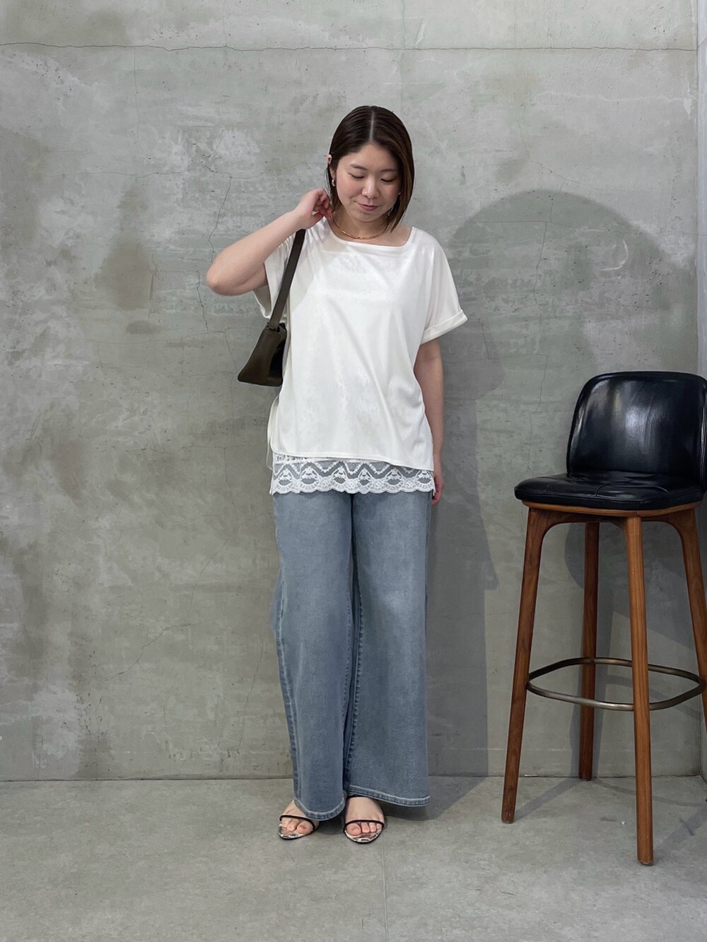 ホワイト系のTシャツ/カットソー、ホワイト系のキャミソール、ブルー系のデニムパンツを着用したレディースの春コーディネートの5枚目の写真