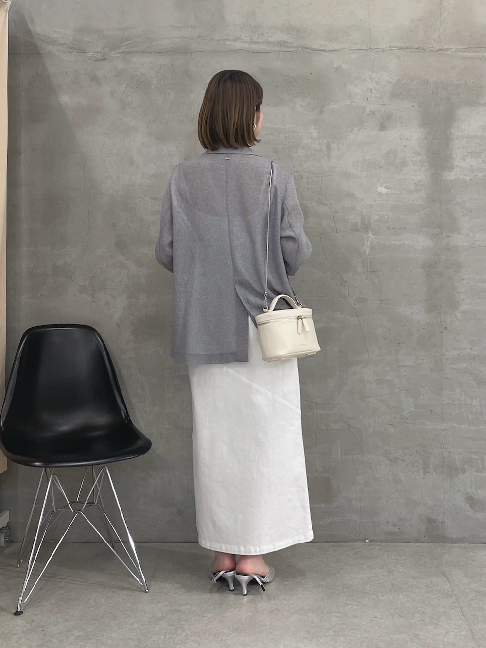 グレー系のテーラードジャケット、ホワイト系のワンピース、ホワイト系のショルダーバッグを着用したレディースの春コーディネートの3枚目の写真
