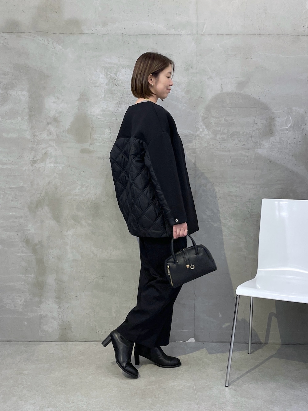 ブラック系のその他アウター、ベージュ系のニット/セーター、ホワイト系のTシャツ/カットソーを着用したレディースの秋コーディネートの2枚目の写真