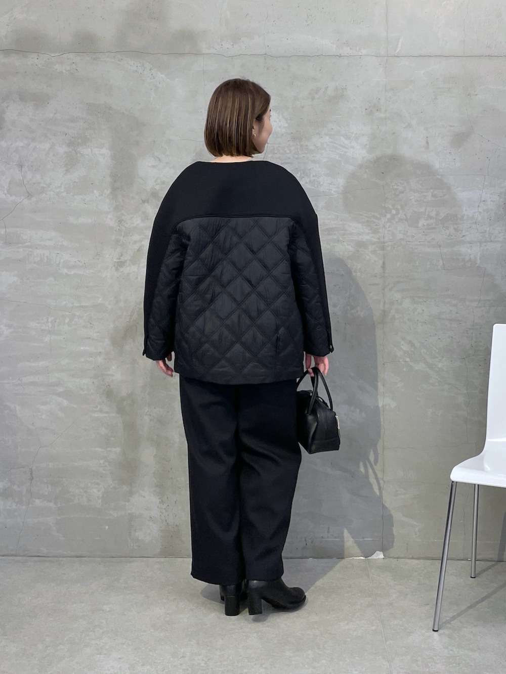 ブラック系のその他アウター、ベージュ系のニット/セーター、ホワイト系のTシャツ/カットソーを着用したレディースの秋コーディネートの3枚目の写真