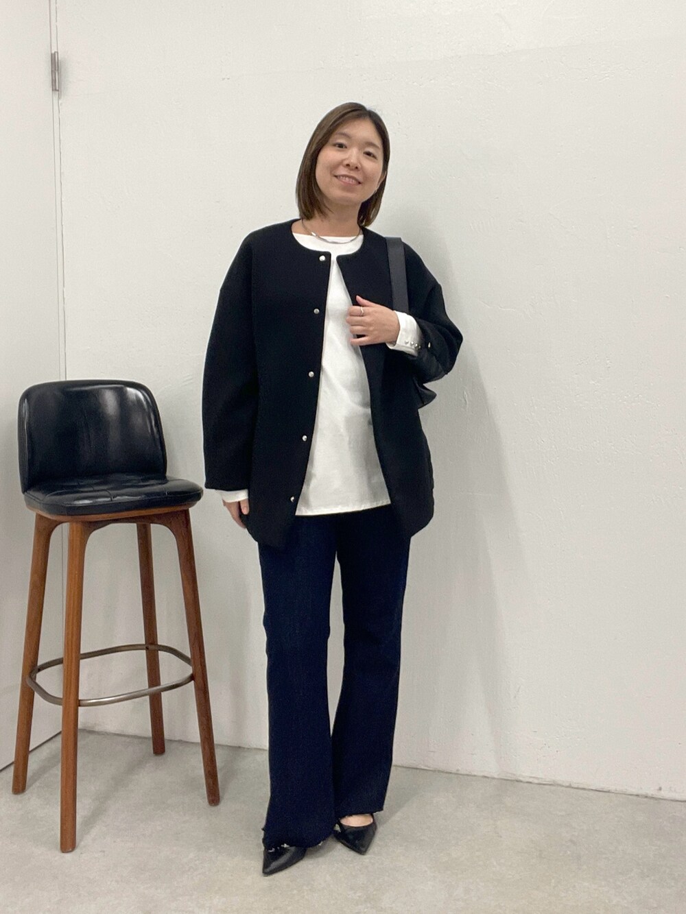 ブルー系のデニムパンツ、ホワイト系のTシャツ/カットソー、ブラック系のその他アウターを着用したレディースの夏コーディネートの5枚目の写真