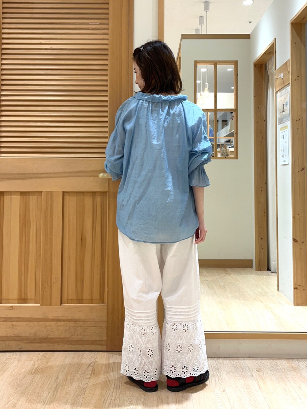 ブルー系のシャツ/ブラウス、ホワイト系のその他パンツ、ブラック系のサンダルを着用したレディースの夏コーディネートの2枚目の写真