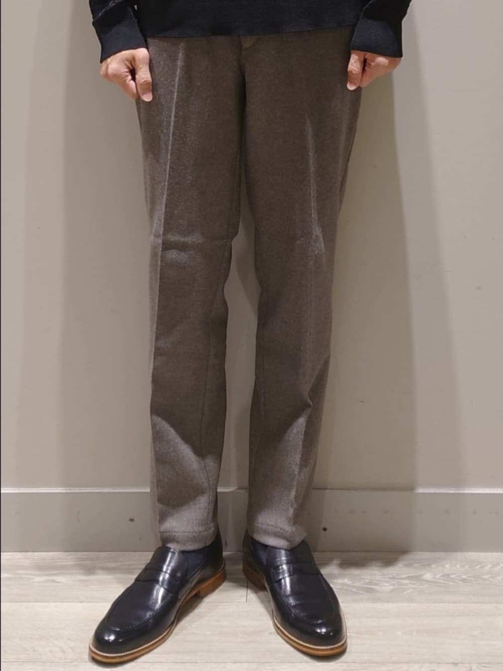 グレー系のテーラードジャケット、グレー系のスラックス、ブラック系のニット/セーターを着用したメンズの冬コーディネートの7枚目の写真