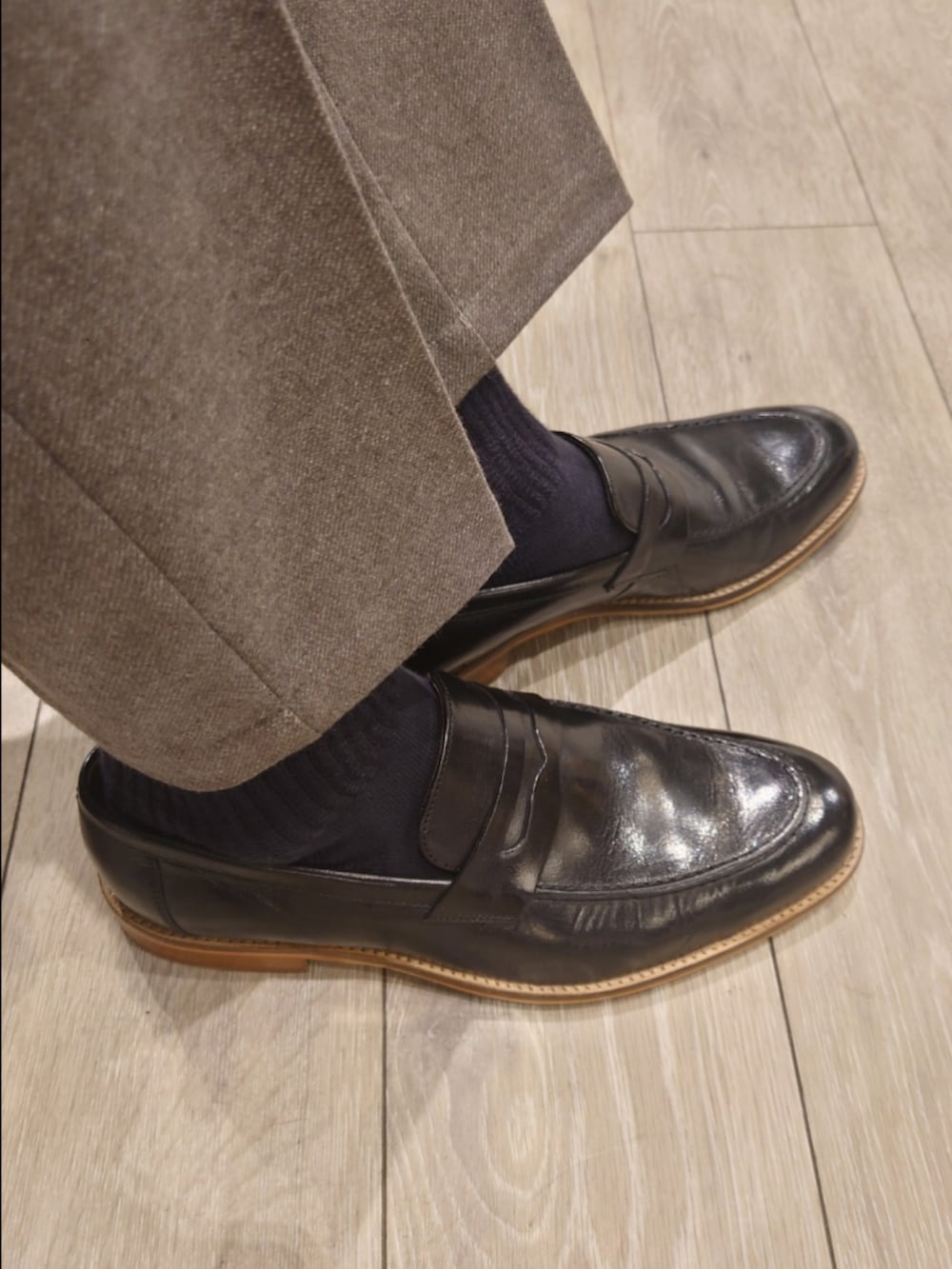 グレー系のテーラードジャケット、グレー系のスラックス、ブラック系のニット/セーターを着用したメンズの冬コーディネートの8枚目の写真