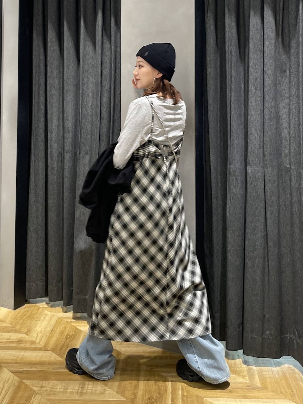 ブラック系のローファー、ブルー系のデニムパンツ、ブラック系のワンピースを着用したレディースの春コーディネートの8枚目の写真