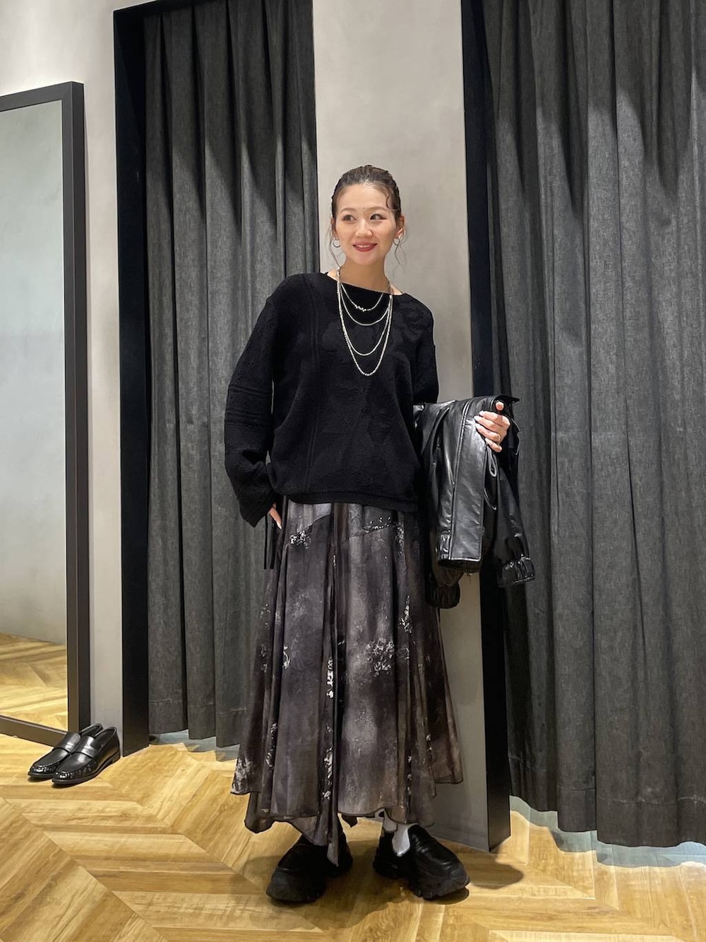 ブラック系のローファー、ブラック系のブルゾン、シルバー系のスカートを着用したレディースの冬コーディネートの4枚目の写真