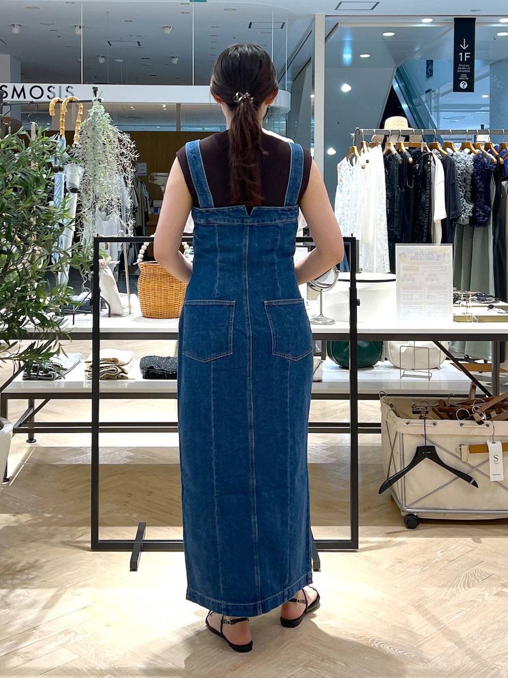 ブルー系のジャンパースカート、ブラック系のサンダル、ブラウン系のニット/セーターを着用したレディースの夏コーディネートの5枚目の写真