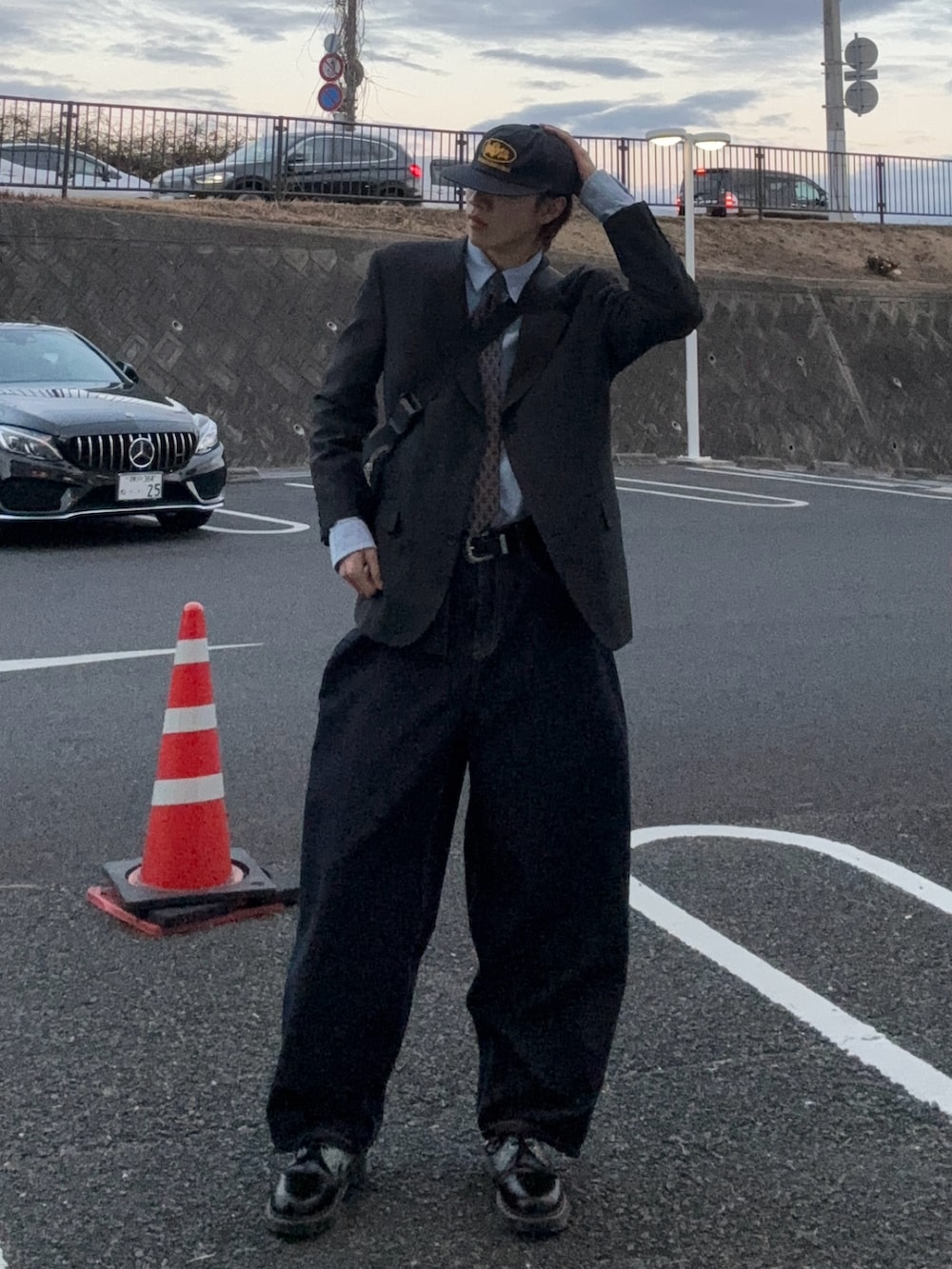 ブルー系のテーラードジャケット、ブルー系のデニムパンツ、ブラック系のブーツを着用したメンズの冬コーディネートの2枚目の写真