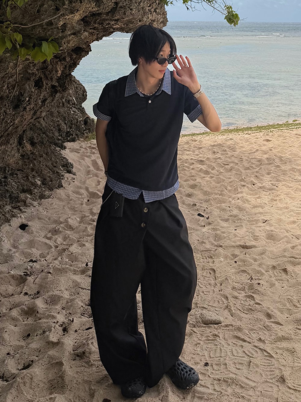 ブルー系のTシャツ/カットソー、ブラック系のスラックス、ブラック系のサンダルを着用したメンズの夏コーディネートの2枚目の写真