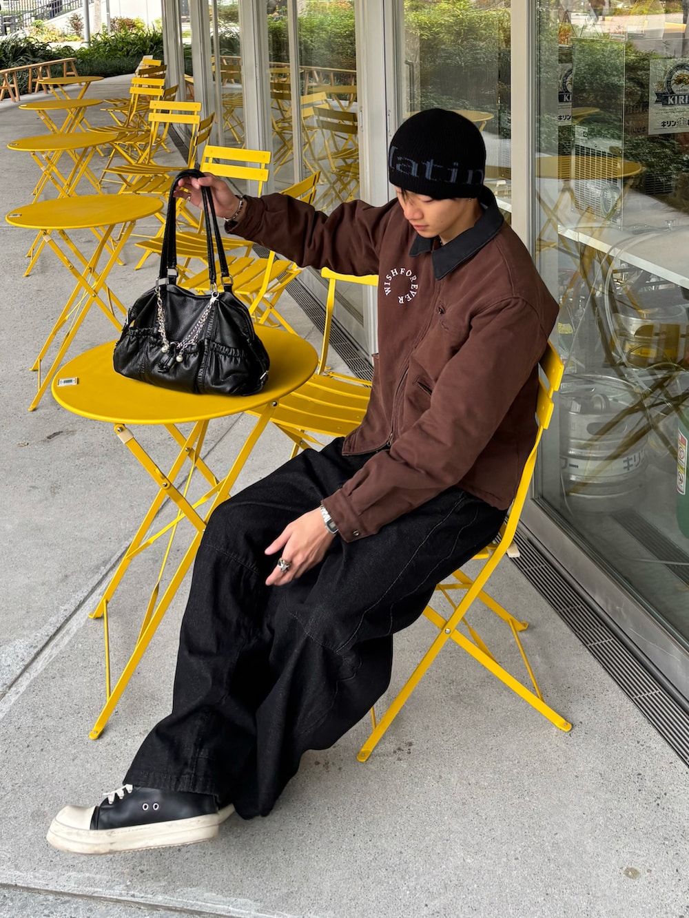 ブラウン系のブルゾン、ブラック系のデニムパンツ、ブラック系のスニーカーを着用したメンズの秋コーディネートの4枚目の写真