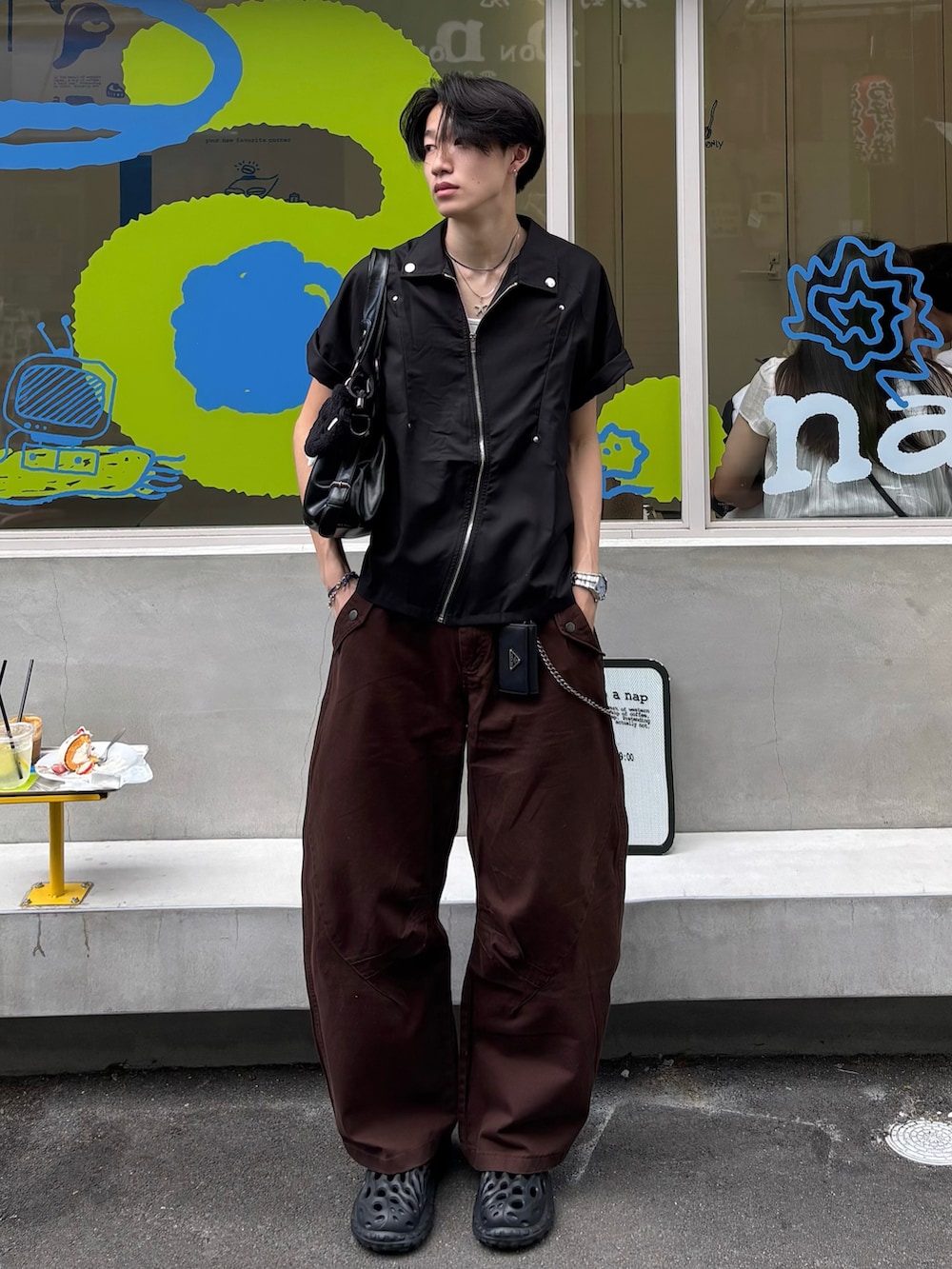 ブラック系のシャツ/ブラウス、ブラウン系のチノパンツ、ブラック系のサンダルを着用したメンズの春コーディネートの2枚目の写真