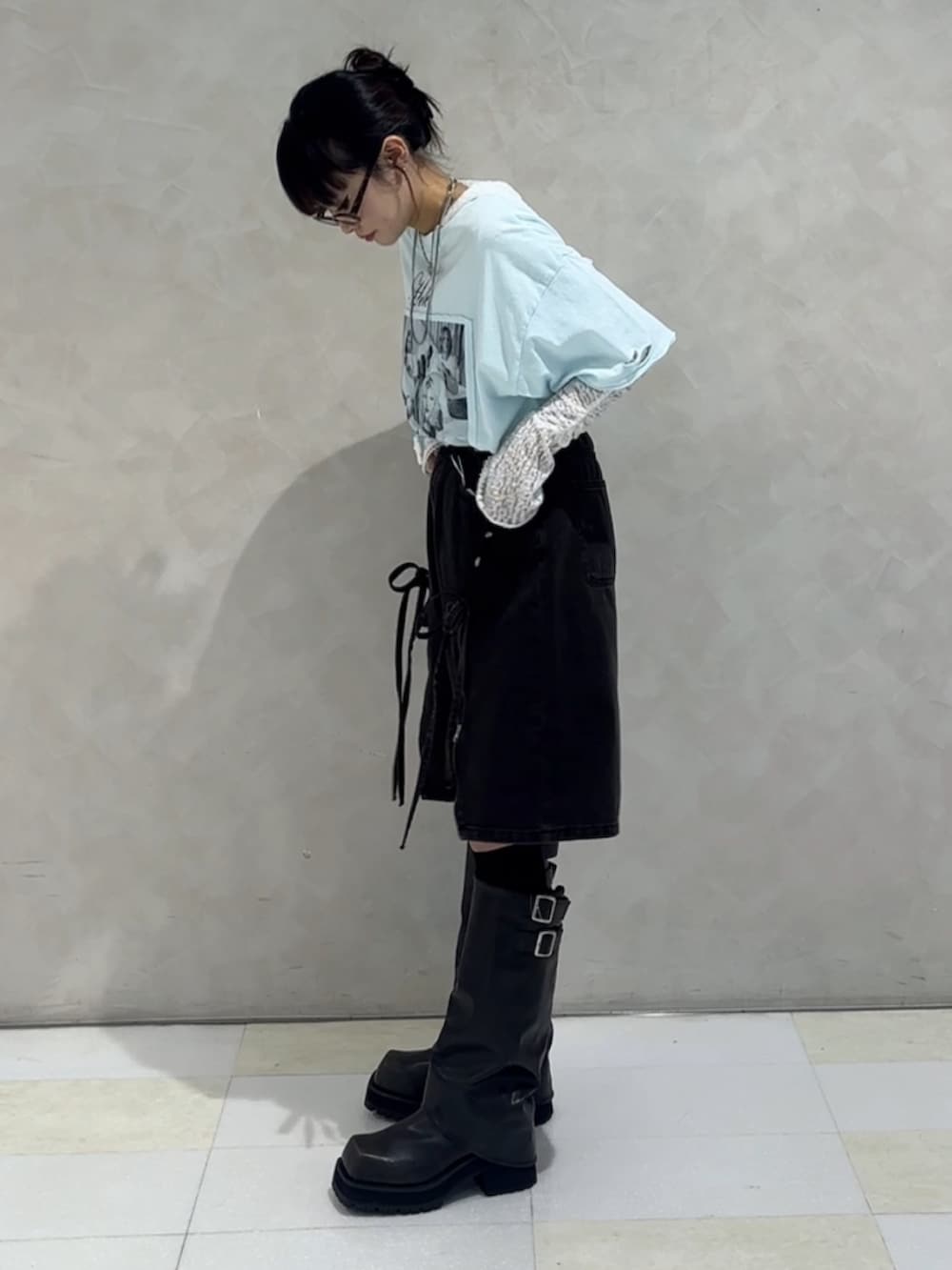 ブラック系のブーツ、ブルー系のデニムパンツ、ホワイト系のTシャツ/カットソーを着用したレディースの秋コーディネートの3枚目の写真