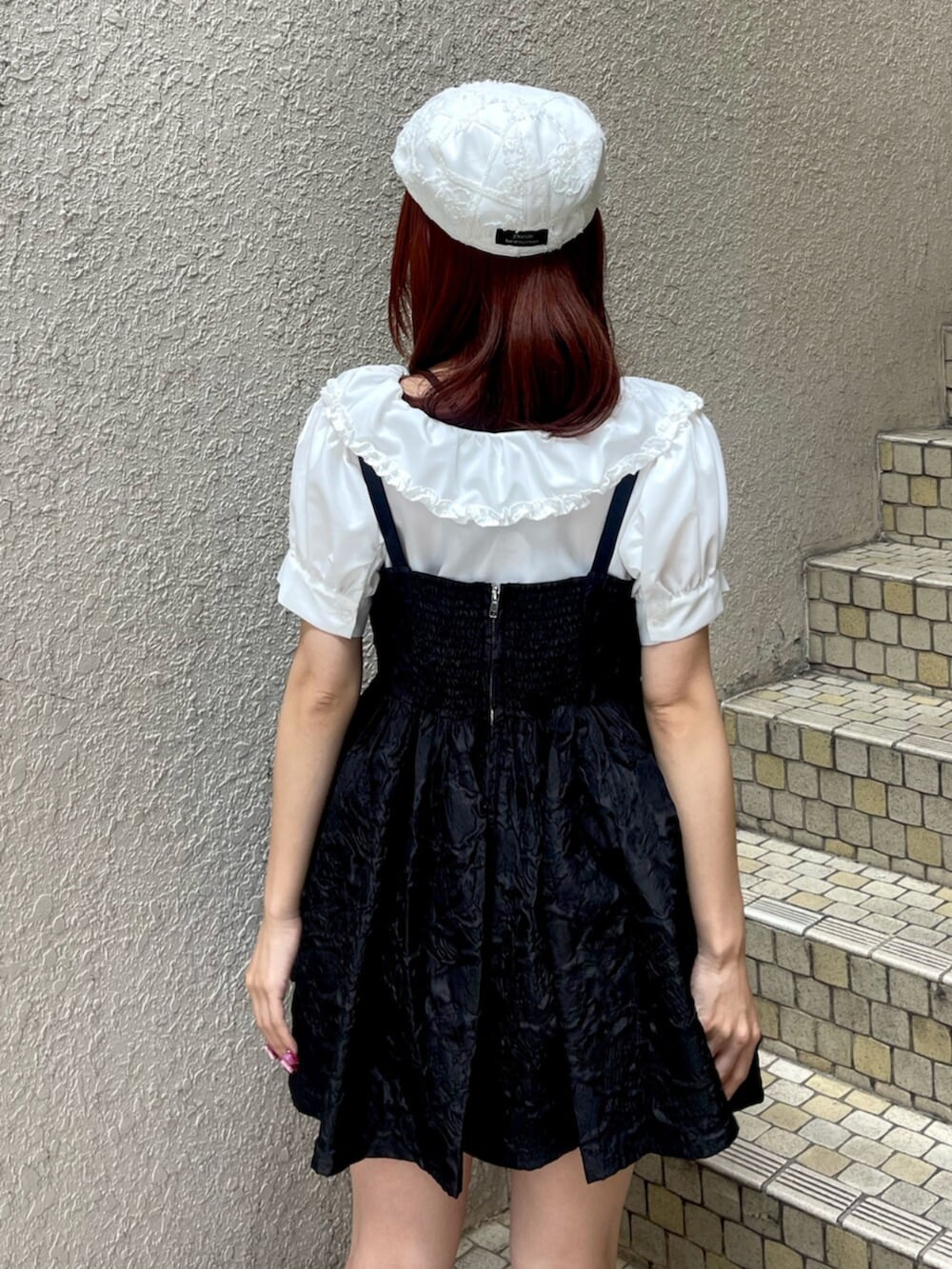 ブラック系のブーツ、ブラック系のワンピース、ホワイト系のシャツ/ブラウスを着用したレディースの夏コーディネートの7枚目の写真