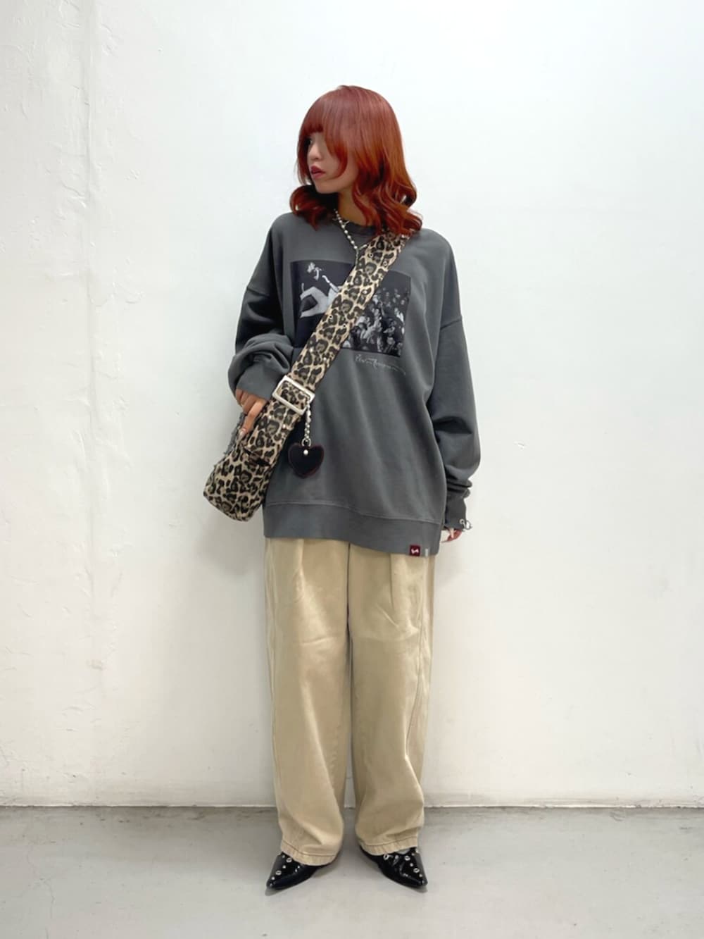 ブラック系のTシャツ/カットソー、ベージュ系のデニムパンツ、ブラウン系のショルダーバッグを着用したレディースの秋コーディネートの2枚目の写真