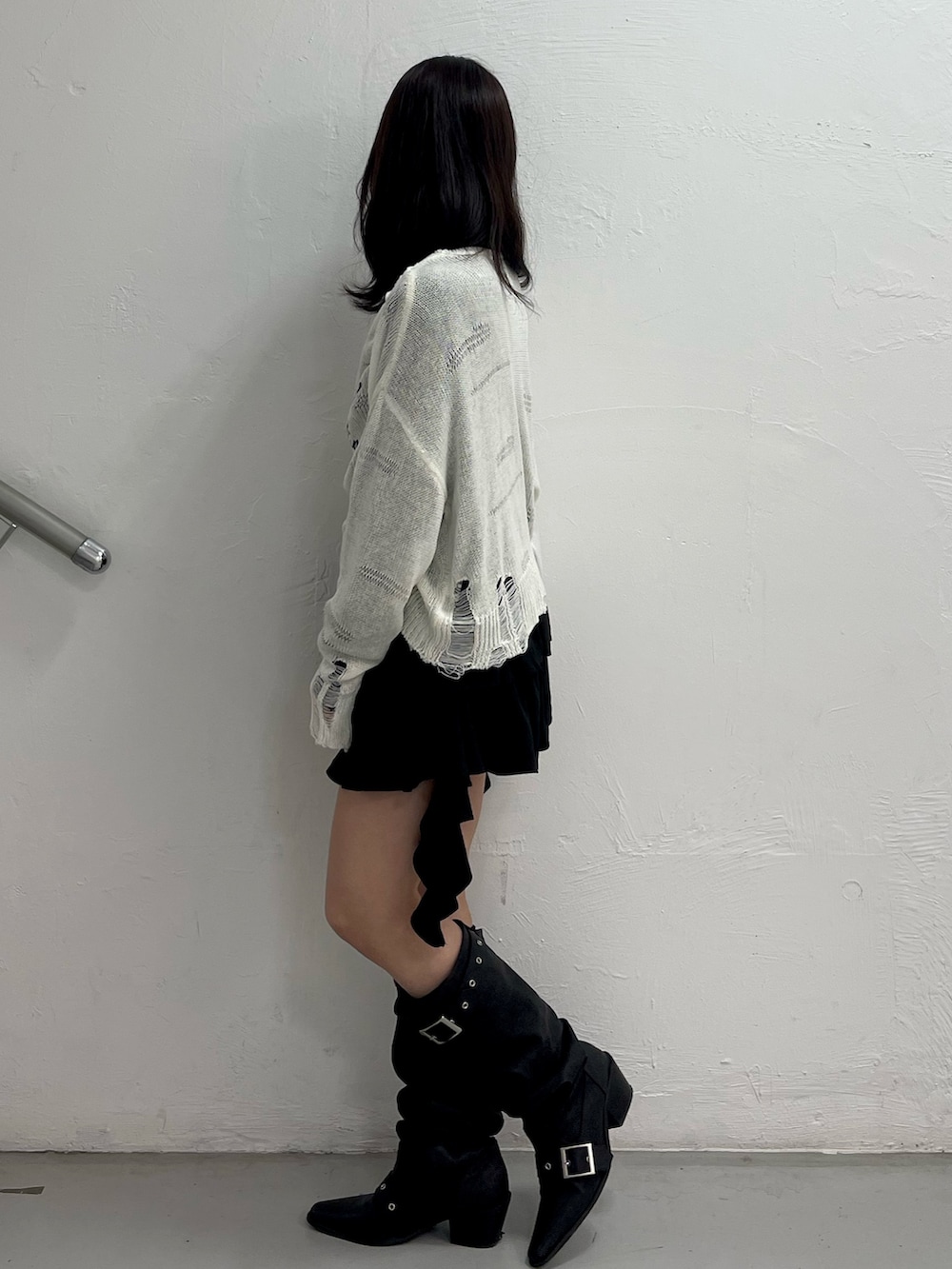 ホワイト系のニット/セーター、ブラック系のシャツ/ブラウス、ブラック系のブーツを着用したレディースの春コーディネートの3枚目の写真